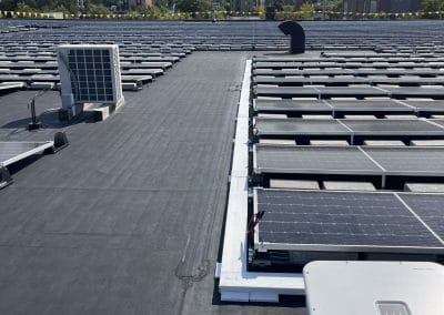 Ballasted solar panels sit on EPDM rubber roofing at Harvard