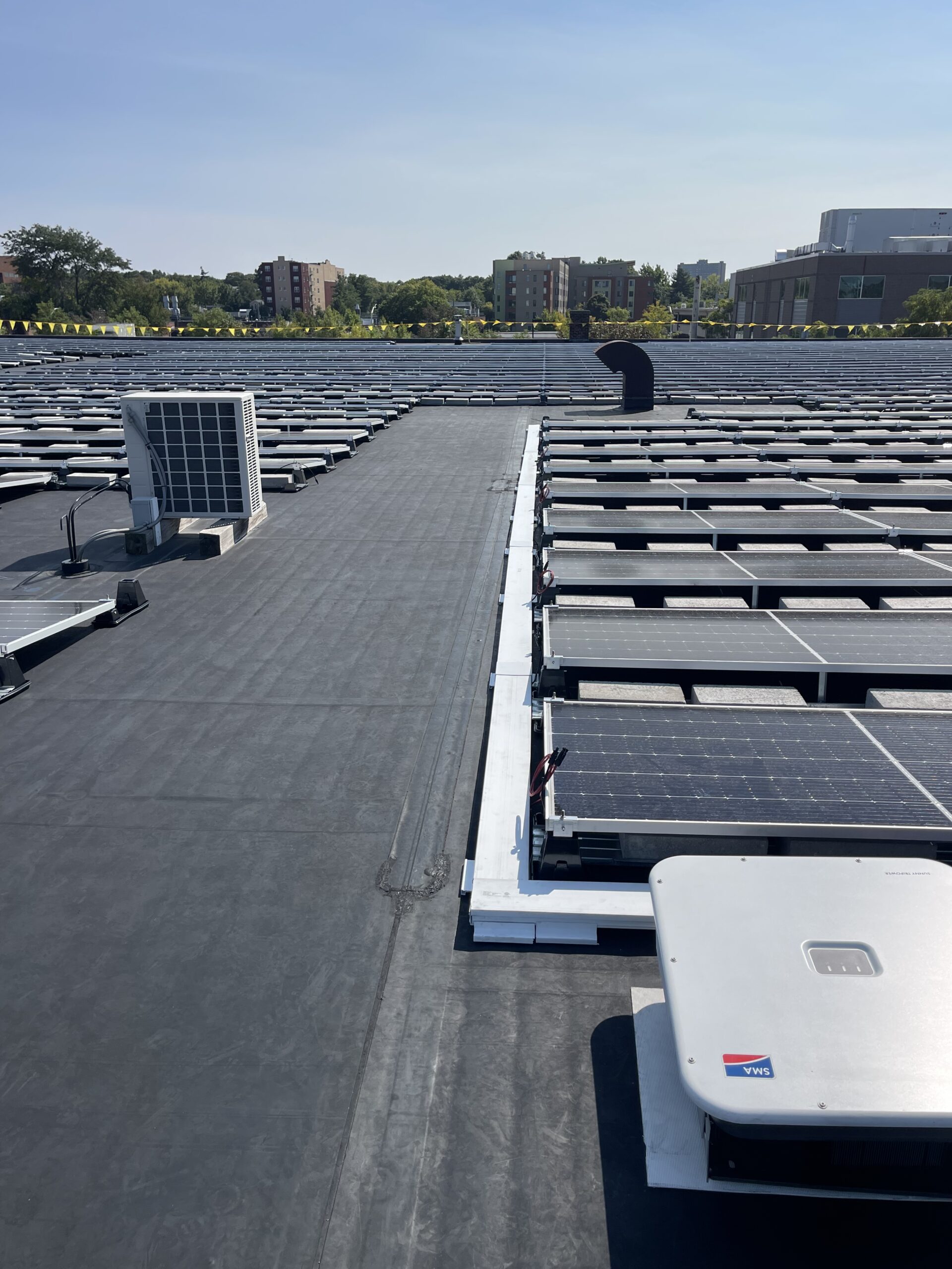 Ballasted commercial solar installation installed atop EPDM rubber roofing at Harvard University