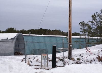 A photo of a site visit showing a commercial utility meter next to the service pole on a snowy day.
