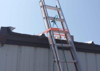 Photo of a ladder leaned up against a building for solar workers to climb