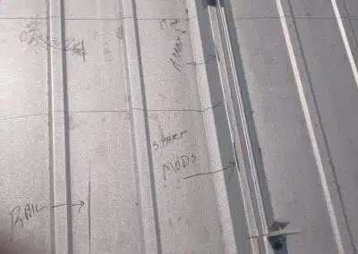 Photo of measurements written in pencil on the rooftop to ensure we place the bolts in the perfect spots