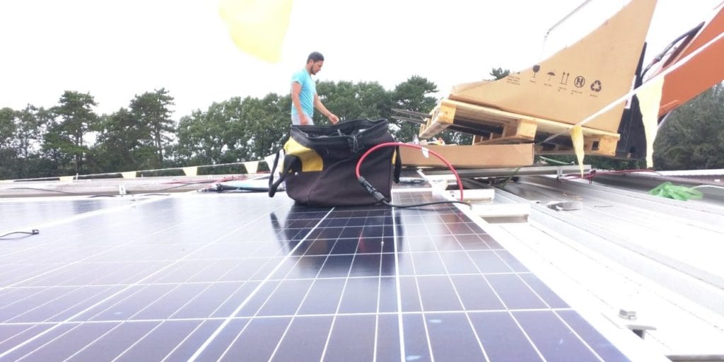 image of man installing commercial solar panels
