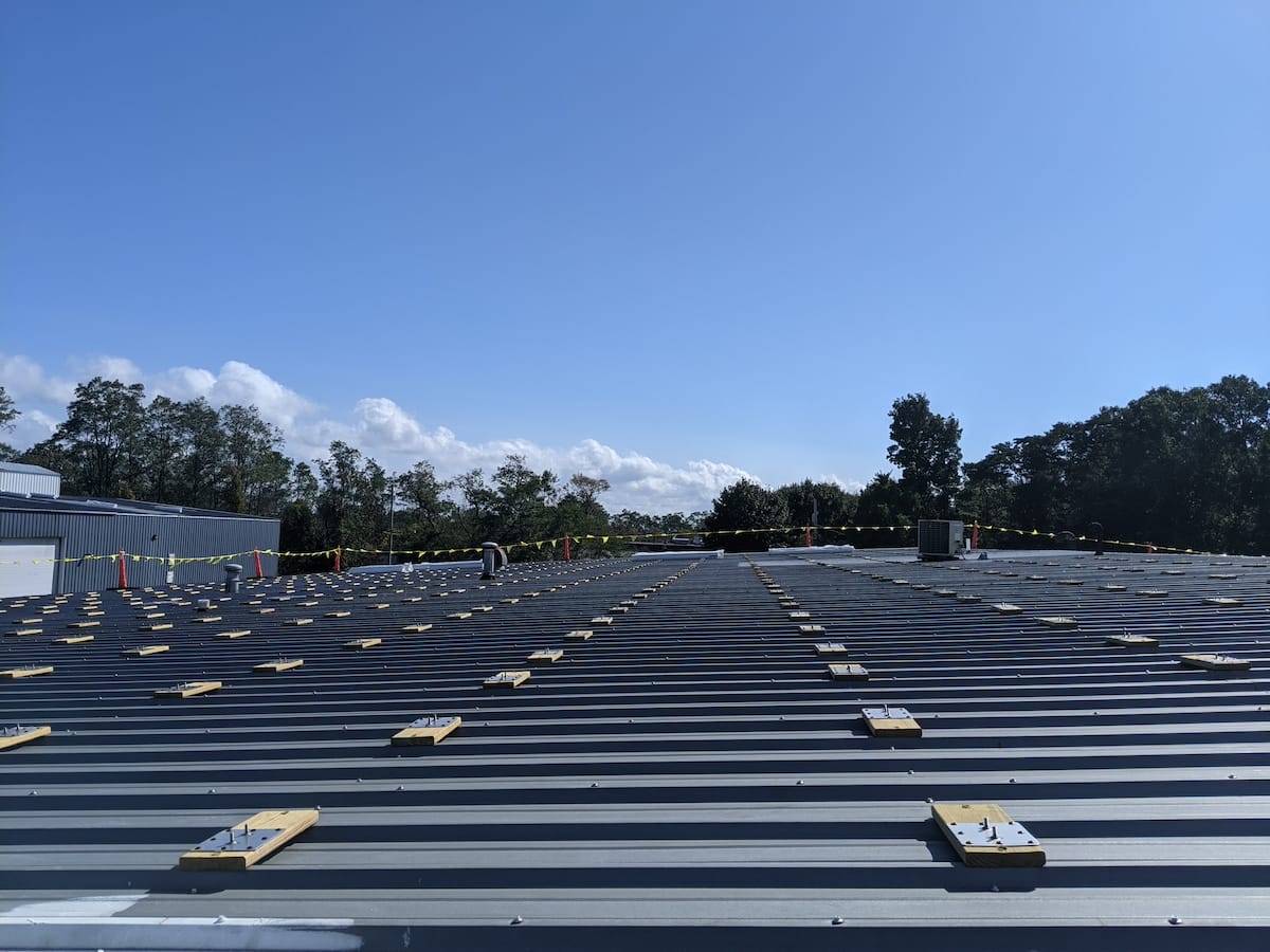 Footings and flashings meticulously aligned as part of commercial solar install