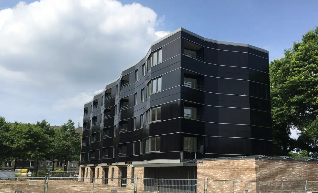 A picture of an apartment building in the Netherlands is covered with solar siding