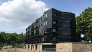 A picture of an apartment building in the Netherlands is covered with solar siding