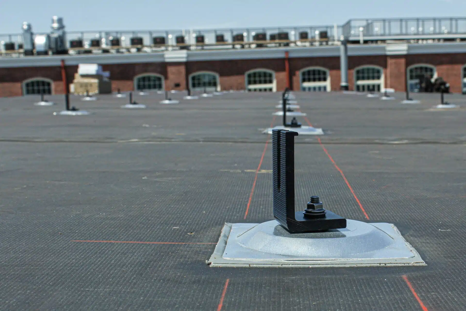 Flashing on flat EPDM roof connects to L-foot, provides a water tight seal