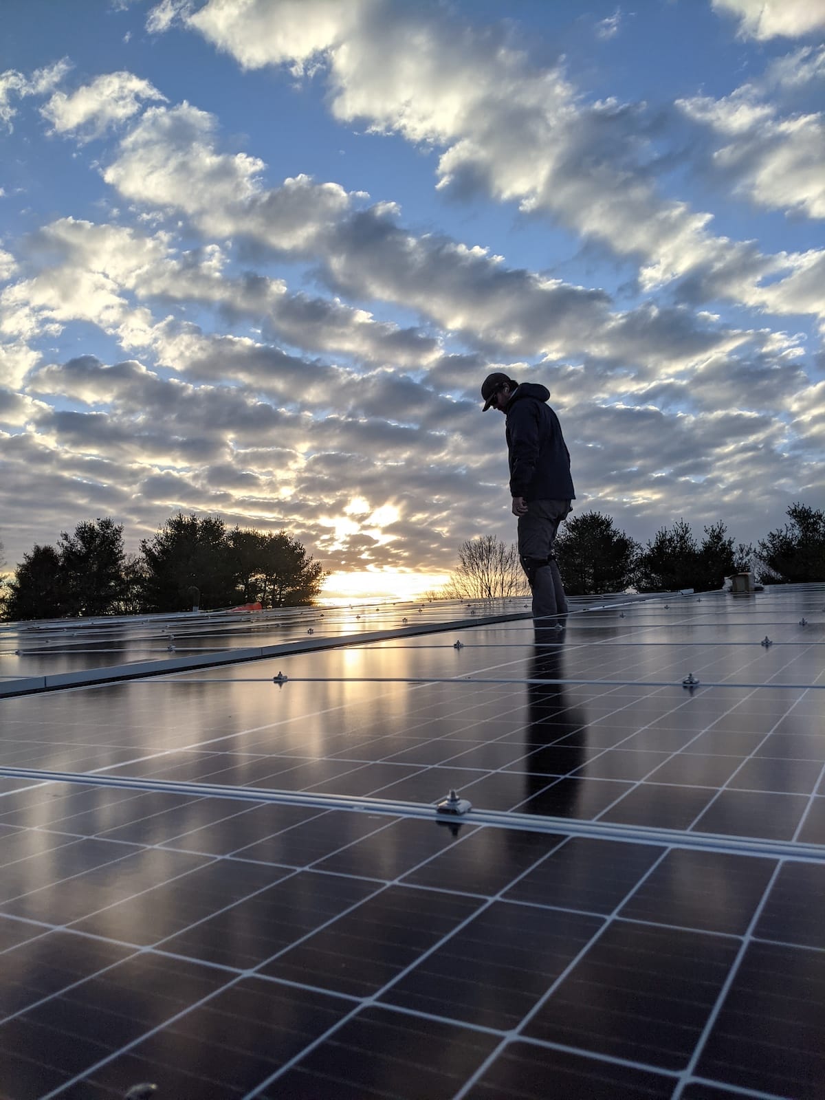 Installer looks over completed installation at sunset