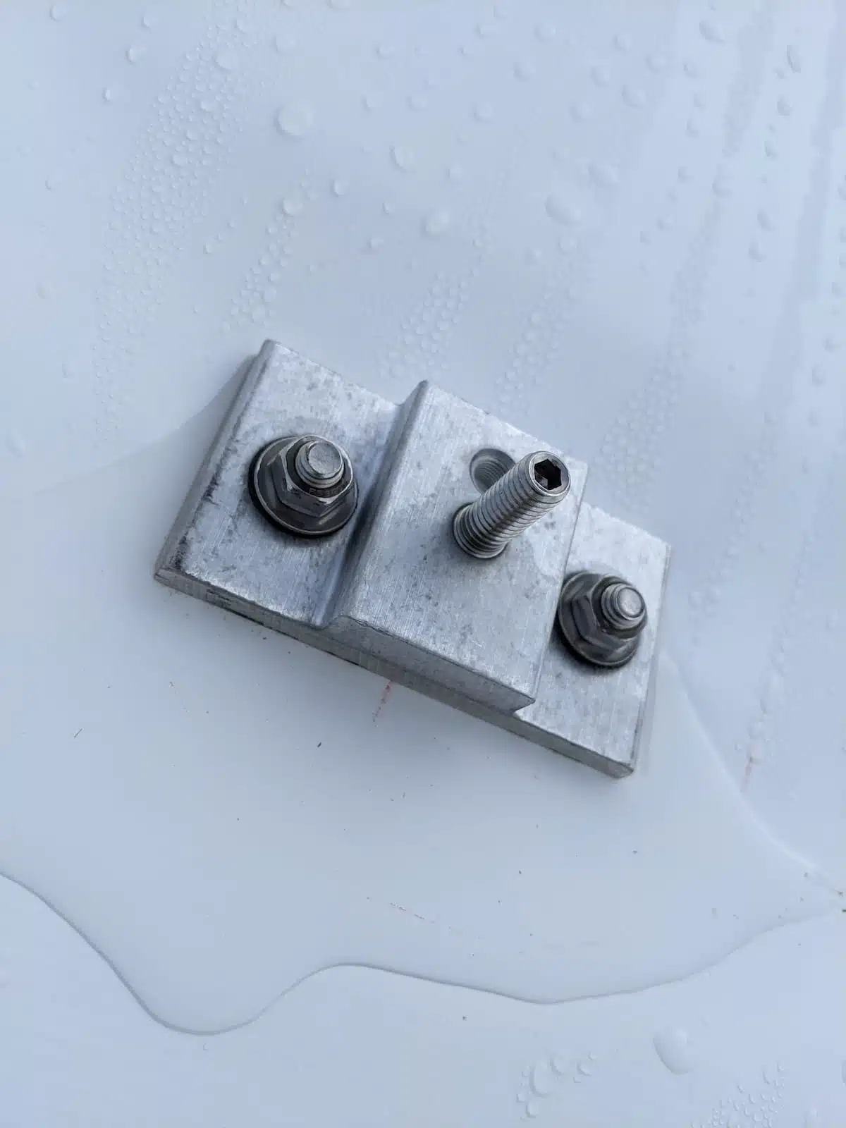 Commercial solar installation flashing hardware on TPO roof